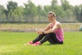 Athlete girl grass using smartphone headphones sitting grass