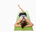 Woman who practices yoga relaxed lying on the mat face down on a white background. Royalty Free Stock Photo