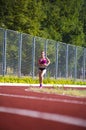 Athlete girl running at the stadium