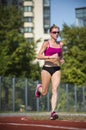 Athlete girl running at the stadium