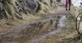 Athlete girl running on trail path.detail on legs and puddle spray.Real people woman runner sport training in autumn or Royalty Free Stock Photo