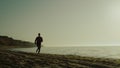 Athlete girl sprint outdoors at sunrise. Woman running beach in sportswear. Royalty Free Stock Photo