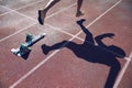 Athlete in Gold Shoes Sprinting Across Starting Line