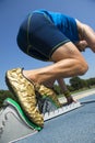 Athlete in Gold Shoes on Starting Blocks Royalty Free Stock Photo