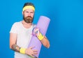 Athlete guide stay in shape. Man bearded athlete hold fitness mat and tape measure. Athlete professional coach motivated