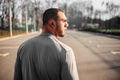 Athlete in headphones before jogging in park Royalty Free Stock Photo