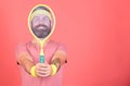Athlete hipster hold tennis racket in hand red background. Man bearded hipster wear sport outfit. Tennis player beginner Royalty Free Stock Photo