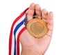 Athlete holding gold medal with ribbon on his hand Royalty Free Stock Photo