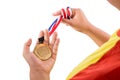 Athlete holding gold medal with ribbon on his hand Royalty Free Stock Photo