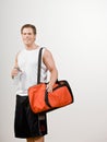 Athlete holding gym bag and water bottle