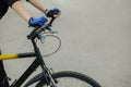 Athlete holding hands handlebar. In the hands of put on blue gloves. Cycling. Royalty Free Stock Photo