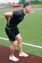 The athlete is holding on to his back. The concept of pain in sn down during a workout