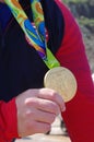 Athlete holds Olympic gold medal