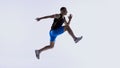 Athlete jumping forward in extended mid-stride. Royalty Free Stock Photo