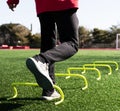 Athlete jumping on one leg over yellow mini hurdles Royalty Free Stock Photo