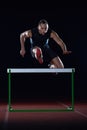 Athlete jumping over a hurdles Royalty Free Stock Photo