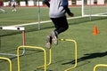 Athlete jumping over yellow hurdles