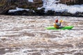 An athlete on a kayak floats on the river. the stormy river is a test for the strong