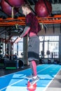 Athlete keeps balance while standing with one foot on a weight
