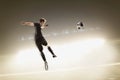 Athlete kicking soccer ball in stadium Royalty Free Stock Photo