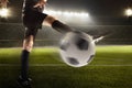 Athlete kicking soccer ball in stadium Royalty Free Stock Photo