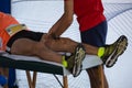 Athlete lying on a Bed while having Legs Massaged after a Physical Sports Workout