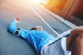 Athlete lying on the street after running session and resting at sunset Royalty Free Stock Photo