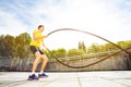 Athlete making wave movement with muscle rope