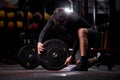 Athlete male adding weight plates on his barbell, preparing for weightlifting workout at gym Royalty Free Stock Photo