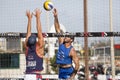 Athlete man beach volleyball spike and defense. Wall on the net. Arms up