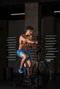 Athlete man biking in the gym. Royalty Free Stock Photo