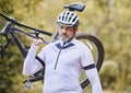 Athlete, man and carrying mountain bike outdoor for cardio exercise, sports race and training in nature. Mature cyclist Royalty Free Stock Photo