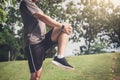 Athlete man doing some stretching exercises legs before running