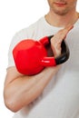 Athlete man holding the red kettlebell Royalty Free Stock Photo