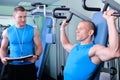 Athlete man with personal fitness trainer