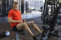 Athlete man pumping up muscles in gym. muscle guy workout. exercises for press, biceps, legs. active healthy lifestyle.