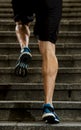 Athlete man with strong leg muscles training and running urban city staircase in sport fitness and healthy lifestyle concept Royalty Free Stock Photo