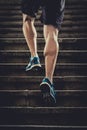 Athlete man with strong leg muscles training and running urban city staircase in sport fitness and healthy lifestyle concept Royalty Free Stock Photo