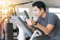 Athlete men, sport exercise concept.handsome man training on bicycle machine at gym in morning. People workout on machine Royalty Free Stock Photo