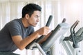 Athlete men, sport exercise concept. handsome man training on bicycle machine at gym in morning. People workout on machine Royalty Free Stock Photo