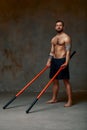 athlete men with stick training karate using sports tool in studio on gray lights background