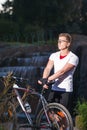 Athlete with Mountain Bike Posing Against Waterfall Outdoors Royalty Free Stock Photo