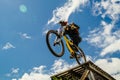 athlete mountainbiker edge of drop downhill