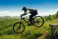 athlete mountainbiker jump drop downhill in flight Royalty Free Stock Photo