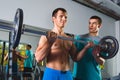 Athlete muscular bodybuilder and personal trainer in the gym training with barbell Royalty Free Stock Photo