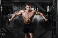 Athlete muscular bodybuilder training on simulator in the gym Royalty Free Stock Photo