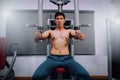 Athlete muscular bodybuilder training on simulator in the gym, strong male.Close Up Men in Gym Exercise Concepts for Body Health. Royalty Free Stock Photo