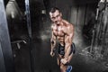 Athlete muscular bodybuilder training on simulator in the gym Royalty Free Stock Photo