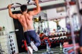 Athlete muscular fitness male model pulling up on horizontal bar