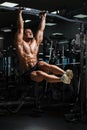 Athlete muscular fitness male model pulling up on horizontal bar